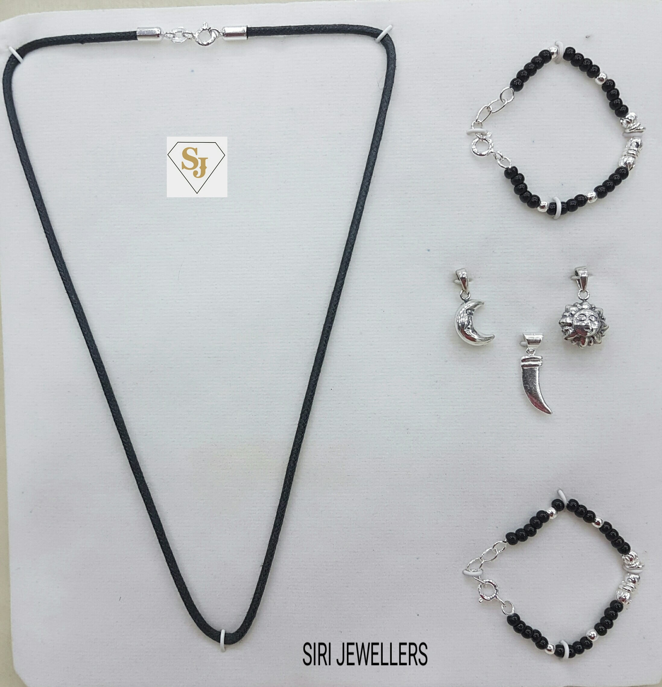 92.5 Silver baby set for new borns the pack contains 2 drushti bangals one black thread and 3 pendents .... very unique item .. lets welcome the baby by adding more colourfull gifts