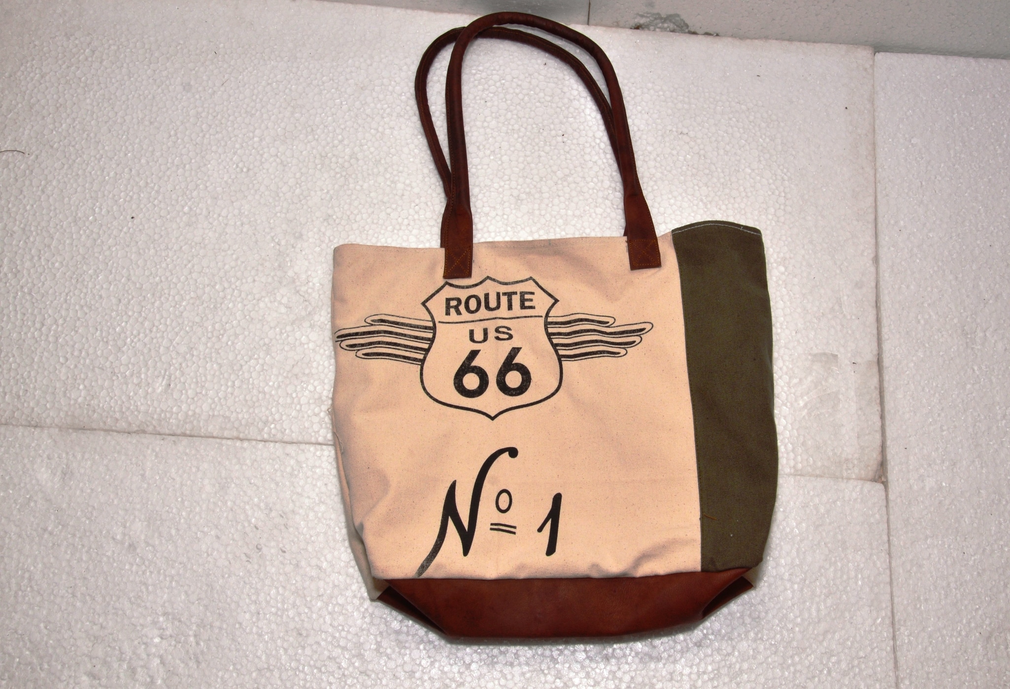 Functional and Stylish: tote includes contrast stitching, quality metal hardware, and slender shoulder straps. Fits 15.6