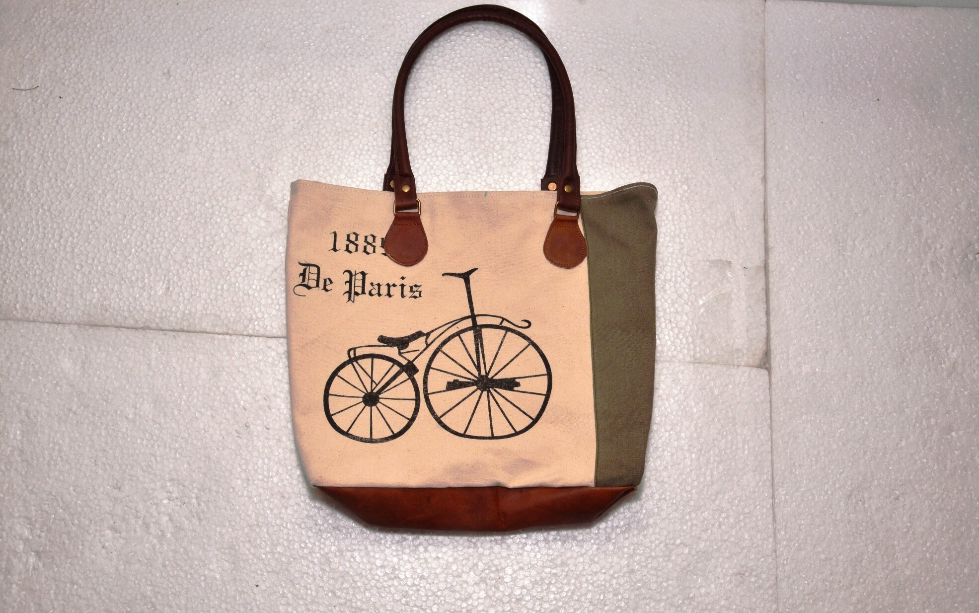 Functional and Stylish: tote includes contrast stitching, quality metal hardware, and slender shoulder straps. Fits 15.6