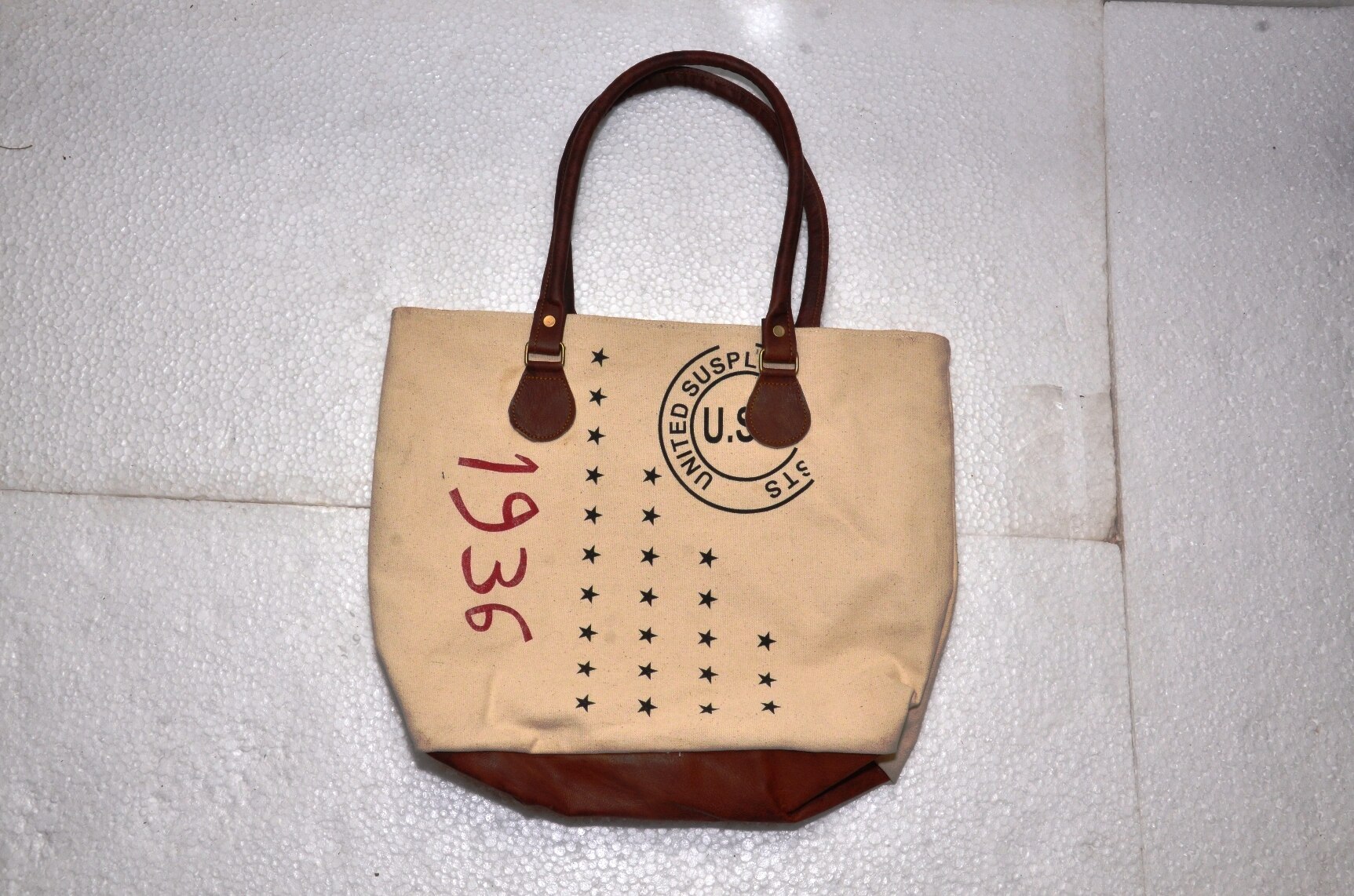 Functional and Stylish: tote includes contrast stitching, quality metal hardware, and slender shoulder straps. Fits 15.6