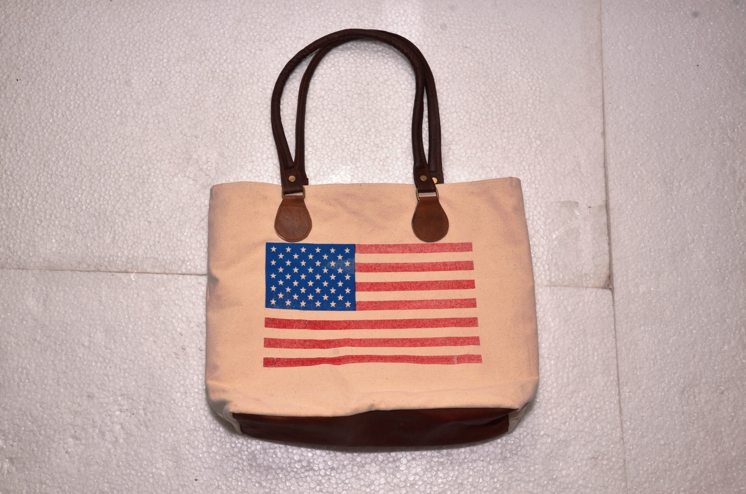 Functional and Stylish: tote includes contrast stitching, quality metal hardware, and slender shoulder straps. Fits 15.6