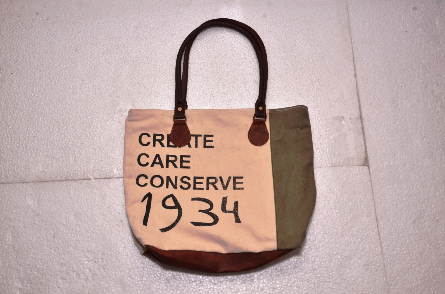Functional and Stylish: tote includes contrast stitching, quality metal hardware, and slender shoulder straps. Fits 15.6
