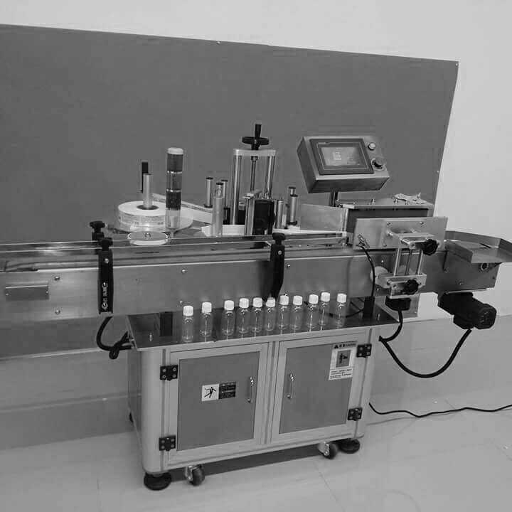 The Automatic Vertical Sticker Labeling Machine Model EPMST-100 is suita-ble for labeling on Round of Bottles. The Machine incorporates latest sophisticated Micro Processor Control Label Dispensing system with user friendly Sensing system for Label and Product. It is capable of Labeling up to 100 units per minute depending on product diameter and label size. Machine suitable for Vials and Small Sizes of Bottles from Glass, Plastic, PET, HDPE, PP etc. with speed range of 40 to 100 products per minute.
The Sticker Labeling Machine EPMST -100 has its own unique single point syn-chronized speed control system. The Inbuilt Automated Label Length detection systems eliminates any need for manually feeding and storing of Label Length data in memory and retrieving the same every time for change of Label Size & re-starting the machine. The System thus saves valuable time, avoiding machine-down time, and helps achieve higher production.