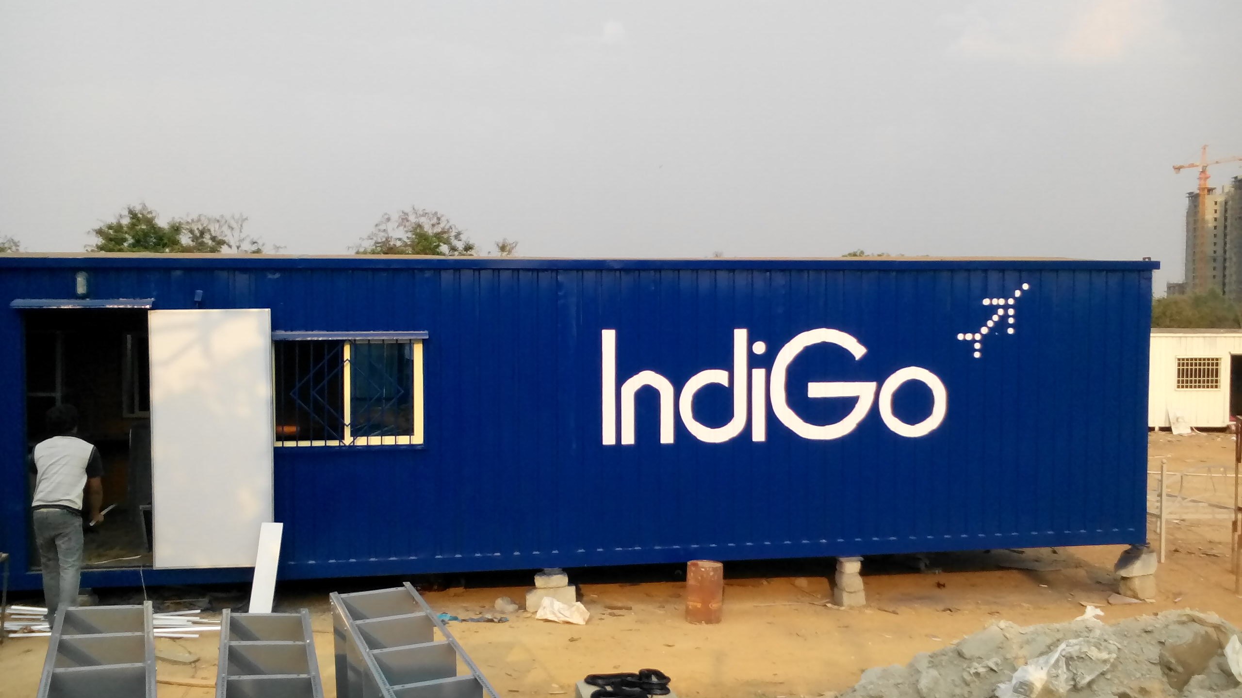 Portable Office Cabin
Technical Specification : We acknowledge with thanks the receipt of your enquiry and are very pleased to quote the best offer as detailed below: Specification of office: 1. Container Dimension – 20’ (length) x 10’ (width) x 8.5’ (height) 2. Floor- MS Structure with M.S pipes, angle & channel weld together + Bison ply board (mixture of cement & wood) 18 mm + 1.0 mm vinyl carpet. 3. Walls – MS Structure + 1.4mm Profiled MS Sheet + 25mm Thermocol Insulation + 25mm of glass wool+ pre-laminated MDF Board of 9mm. Walls are designed to absorber Heat and noise. 4. Roof – MS Structure + 1.2mm Profiled MS sheet + 50mm Glass wool insulation + pre-laminated MDF Board 9mm. Roof are designed to absorber Heat & also with proper sloping and gutters to run water while raining. 5. Doors – One door 3’x 6’with 1.4mm Profiled MS Sheet + 25mm Glass wool insulation + pre-laminated MDF Board with canopy. 6. Windows – Three4’x 3’ powder coated two track Aluminium windows on MS Frame with safety grill and canopy. 7. Electrical– All Electrical wiring are done with 3 wire (phase, neutral & earth) with 2.5sqmm wire .Fittings for 3 tube lights 1x40w with wiring of 1.5sqmm, 2 cabin fans with switches. 16Amps for A/C & 6Amps plug points, 1 bulkhead light outside & 2 MCB. 8. Painting – Metal priming everywhere to with stand rust + Enamel painting exterior – 2 coats.
