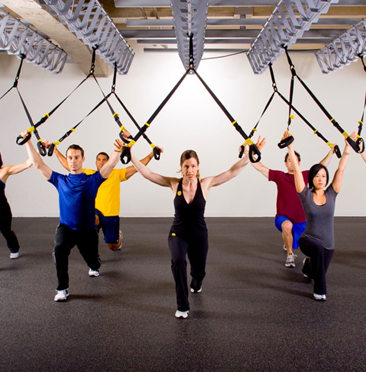 Born in the Navy SEALs, Suspension Training bodyweight exercise develops strength, balance, flexibility and core stability simultaneously.
It requires the use of the TRX Suspension Trainer, a highly portable performance training tool that leverages gravity and the user’s body weight to complete 100s of exercises.
Workout Using the Suspension Trainer
The TRX Suspension Trainer is the original, best-in-class workout system that leverages gravity and your bodyweight to perform hundreds of exercises.
You're in control of how much you want to challenge yourself on each exercise - because you can simply adjust your body position to add or decrease resistance.
THE TRX SUSPENSION TRAINER:
Delivers a fast, effective total-body workout
Helps build a rock-solid core
Increases muscular endurance
Benefits people of all fitness levels (pro athletes to seniors)
Can be set-up anywhere (gym, home, hotel or outside)
By utilizing your own bodyweight, the TRX Suspension Trainer provides greater performance and functionality than large exercises.