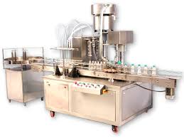 The Electronic PLC Based Filling Machine is compact and highly efficient machine with elegant look. This multi functional multi featured machine meets the GMP requirements of filling for glass, plastic or Aluminum bottles. The flow of liquid is measured and converted in to electronic signals being controlled by micro computer base circuitry. Minimum adjustment required to set different capacities from 500ml to 5 Ltr with varying containers. The entire range can be set on the same machine without any change parts with help of flow meter pulses.
Operation:-
Nozzle goes upwards slowly from the bottom level of bottle towards neck during filling to minimize foaming adjustable nozzle is reciprocating according to filling dose
The filling synchronized with conveyor drive and conveyor drive controlled by Ac frequency drive. The speed can be set in terms of bottles per minute. The conveyor drive consists of a hallow shaft, geared motor controlled by Ac frequency drive. A knob can set the speed of conveyor.
