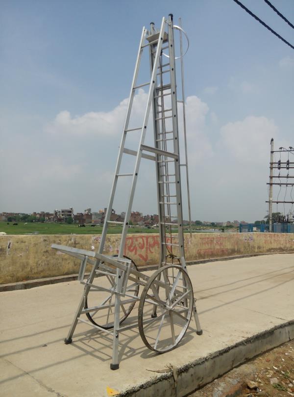 AQPC MODEL No:1002 “AQPC” ALUMINIUM Self Supporting Type Economy Tower Ladder with extension system, made out of Extruded, Tested Quality Hindalco make ALUMINIUM Section of size:- • 66mm x31mm x3mm thick approx. • Steps made of 25mm (1”) dia approx. • fluited aluminium pipe at required distance of 12inch • Inclusive M.S.Pulley. • good quality Sisal/Nylon rope. • self locking arrangements and fitted with 2 Nos. • Large size 3ft dia M.S.Flat fabricated wheels with Ball Bearings having tyre Rubber fixed with the help of Nut Bolts. • Also necessary arrangements for Towing the Ladder handle etc. • At proper size will be provided in addition to Rubber shoes at bottom of all the four legs for making Ladder sturdy and non-slippery. • The Ladder will be complete with railing, a safety ring at the top for safety of the workers. • The width of the Outer Ladder is not less than 300mm.