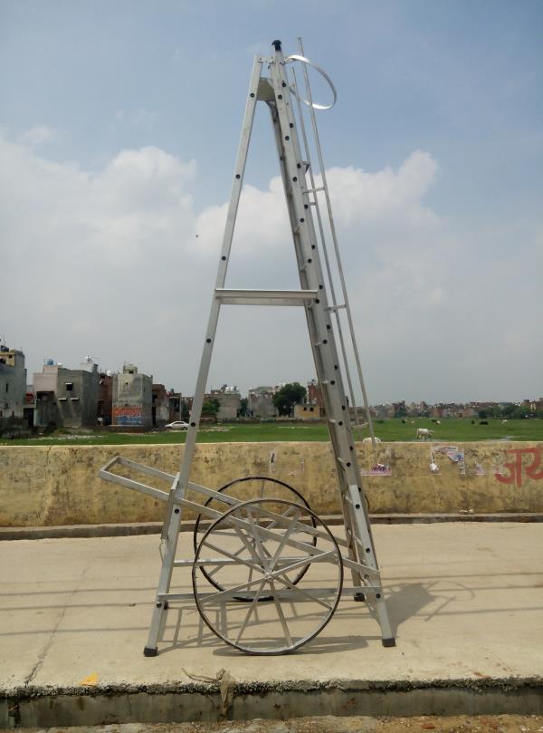 AQPC MODEL No:1002 “AQPC” ALUMINIUM Self Supporting Type Economy Tower Ladder with extension system, made out of Extruded, Tested Quality Hindalco make ALUMINIUM Section of size:- • 66mm x31mm x3mm thick approx. • Steps made of 25mm (1”) dia approx. • fluited aluminium pipe at required distance of 12inch • Inclusive M.S.Pulley. • good quality Sisal/Nylon rope. • self locking arrangements and fitted with 2 Nos. • Large size 3ft dia M.S.Flat fabricated wheels with Ball Bearings having tyre Rubber fixed with the help of Nut Bolts. • Also necessary arrangements for Towing the Ladder handle etc. • At proper size will be provided in addition to Rubber shoes at bottom of all the four legs for making Ladder sturdy and non-slippery. • The Ladder will be complete with railing, a safety ring at the top for safety of the workers. • The width of the Outer Ladder is not less than 300mm.