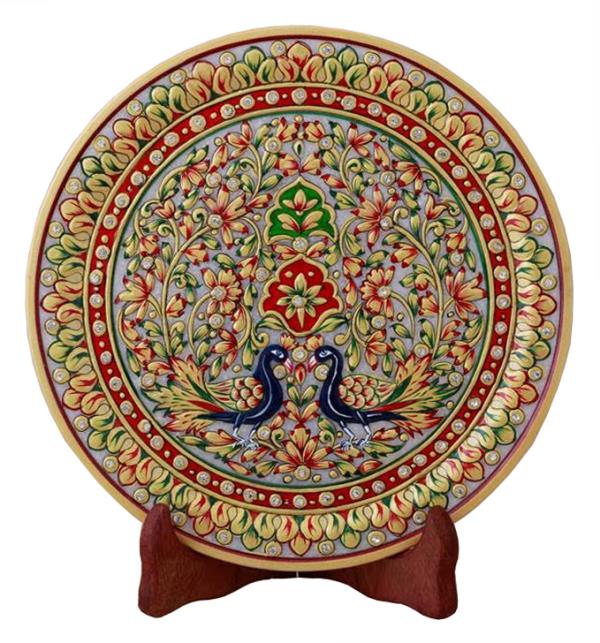 The decorative plate has an interesting feel as it will make any corner glow. Resting on a wooden stand, the product has a mughal floral theme with beautiful painting done on it. This style of painting is done in all royal palaces of Rajasthan.Traditional colors, gold painting and kundans further embellish it.other than personal utility, it can be used for gifting too. Being handcrafted, it may have mild variations in the design and colour. It can be a good Gift for wedding , Anniversary and house warming