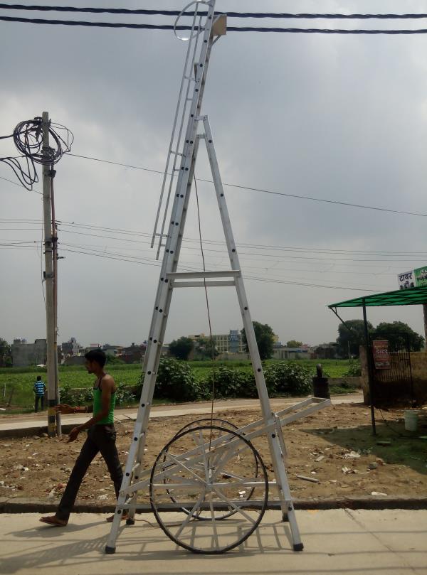 AQPC MODEL No:1002 “AQPC” ALUMINIUM Self Supporting Type Economy Tower Ladder with extension system, made out of Extruded, Tested Quality Hindalco make ALUMINIUM Section of size:- • 66mm x31mm x3mm thick approx. • Steps made of 25mm (1”) dia approx. • fluited aluminium pipe at required distance of 12inch • Inclusive M.S.Pulley. • good quality Sisal/Nylon rope. • self locking arrangements and fitted with 2 Nos. • Large size 3ft dia M.S.Flat fabricated wheels with Ball Bearings having tyre Rubber fixed with the help of Nut Bolts. • Also necessary arrangements for Towing the Ladder handle etc. • At proper size will be provided in addition to Rubber shoes at bottom of all the four legs for making Ladder sturdy and non-slippery. • The Ladder will be complete with railing, a safety ring at the top for safety of the workers. • The width of the Outer Ladder is not less than 300mm.