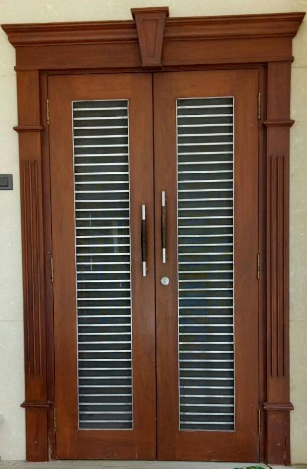 Wooden safty door double shatter door withss road ss road size 12 mm and teak wood side arch design best looking door size 79 inch by 39 inch thickness 36 mm with polish