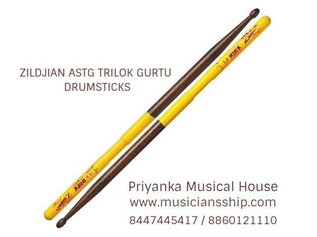 Zildjian ASTG Trilok Gurtu Drumsticks-Walnut Stain.Designed by World Percussion Master Trilok Gurtu. Unique thumb groove, jazz dimensions and tip, and a double yellow DIP handle for control.