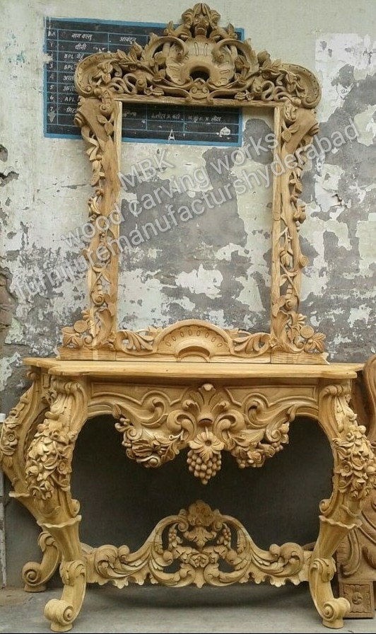 Wooden console table antiques model catalogue design in 3d carving best hand carving design good looking table and mirrors frame big size in side mirrors size 3ft by 2ft very nice table leg design and front carving design with polishing natural color any other color for require this design order for ready time to work 20 to 25 days after deliver