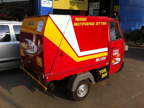 ‘JETMAN’ High-Pressure Sewer Jetting Machine suitable for effective and efficient cleaning of chocked underground drainage/sewage lines. It is capable of cleaning chocked drainage/sewage lines ranging from 50mm dia to 900mm dia and more. The operation is carried out by a specially designed nozzle which delivers high-pressure water into the sewage/drainage lines. It is developed on HCV / LCV /MINI Truck, Trailer Chassis & 3 Wheeler Chassis depending upon the tank and pump capacity. Apart from specific Jetting Operation, this Multipurpose Machine can be used for Cleaning of Toilet Blocks, Foot Paths, Cleaning / Servicing of Vehicles and also to extinguish a small fire and to spray pesticide.__Working__High pressure jetting is the preferred method of re-establishing water flow. It not only removes blockage but also washes away all debris found within the pipe. High-pressure water jet is faster and less labour intensive than use of a mechanical rodding or cable machines. High pressure jetting units maintain constant working pressure and cleaning power at the nozzle end while mechanical machines will lose cutting and torque power as rod or cable distances increase within pipelines from the point of entry.High pressure jetting has another advantage over cable or rodding machines. Where access is difficult, a lightweight, flexible jet hose is a safer and more practical solution. Pipelines that are suspended from ceilings or catwalks are easily cleaned using a high-pressure jetting hose rather than a heavy, cumbersome mechanical drain cleaning machine. Cleaning vertical stacks or vents is easier with a high pressure jetting unit and lightweight jetting hose than with heavy drain cleaning cables or rods.SPECIFICATION:VEHICLE: Three-wheeler chassis JETTING PUMP •	MAKE:	Imported ‘Comet’ Brand •	CAPACITY: 	13 LPM And Pressure up to 200Bar •	R.P.M.:	3400	Construction & MATERIAL QUALITY •	Forged brass pump head and conrods with high mechanical resistance and corrosion proof. •	Highly efficient S.S check valve and piston guide.•	Solid ceramic plunger highly corrosion and abrasion proof.•	Adjustable unloaded with inner S.S parts and fitted with a check valve that ensures reliability and nozzle protection zero pressure in by-pass condition fixed and adjustable detergent ejector •	Anodized aluminium die-cast crankcase fins that ensure grant optimal oil temperature. DRIVE: 	Direct Coupled With  Diesel Engine ENGINE 	•	MAKE /TYPE:	GREAVES make 4 strokes, air-cooled, single piston diesel engine rope start or electric start•	PERFORMANCE: 	10 hp at 3000 rpm (NB-DIN 6270)•	STARTER:	Battery operated 12v .power required from vehicle’s battery.•	RPM:	3000TANK 	•	Capacity: 	500 Liters.•	SHAPE: 	Cylindrical Horizontal Fitted. HOSE REEL 	•Horizontally Fitted Manually Operated Type •Fitted With Heavy Duty S.S Rotary Joint •Capable Of Winding 30M Long jetting Hose JETTING HOSE 	•TYPE: 	Special High-Pressure jetting Hose •HOSE I.D.:	Ø ¼”•HOSE LENGTH: 	30 m.	WASHING/SPRAYING HOSE 	•TYPE: 	Special High-Pressure Washing Hose •HOSE I.D.:	Ø 3/8”•HOSE LENGTH: 	10 m.SPRAY GUN:	Imported Comet makes spray gun, which can withstand pressure up to 300 bars. It is very useful for cleaning equipment/container cleaning and also useful for cleaning of toilets/roads/streets etc.SUCTION FILTER:	Imported European AARAG make Y type filterVALVES 1.	Lever operated 3 way L port high-pressure ball valve for main hose reel2.	Lever operated 3-way L port high-pressure ball valve for the auxiliary spray gun.3.	Drain valve ACCESSORIES AND SAFETY DEVICES	1.	Heavy duty glycerin field pressure gauge having a pressure range of 0-300 kg/cm22.	Flexible water level indicator3.	Suction filter to ensure the supply of clean water to the pump.4.	Water level alarm audio/visual5.	Focus light at front and rear6.	Searchlight with extendible wire7.	Tank filling cap at the top of the tank.Panelling:	Paneling made from M.S sq. pipe /M.S angle and covered with 18 g alluminium sheet.REAR DOOR:	Closed in compact hinged type rear door with locking arrangement for the protection of pump and other critical components.Paint 	Two coats of epoxy primerTwo coats of PU paint