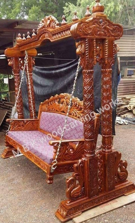 Teak wood carving design sowing side 1 pillars jhoola best handmed carving design best quality teak wood size 7 feet height 6.feet width very comfortable back rest best quality fabric and cushions 42 d n c t foame this jhoola only on order for Raedy time works 30 days