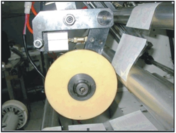 This hot melt glue will stick strong on any kind of bottle surface during heat shrink for the PVC, PET, OPS shrink label in process. Type of Adhesive used is with:Base :Ethylene Vinyl Acetate CopolymerColour : Brownish YellowViscosity : 275-600 cP at 150 degree C, Softening Point : 65-75 degree C, 3.5 Density : 0.99 + 0.03 g/cm3 at 30 degree CApplicator DeviceThis applicator device can be installed in any shrink label center/seaming machine. The glue will be applied on the back side surface of the shrink label approximately thickness 10~15 micron before process center sealing.Label size length is 100 mm, special hot melt glue line width is 10 mm.Suppose price of special hot melt glue is Rs.300/Kg.Cost =0.4 p. per glue line.