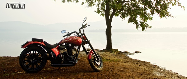 Whoever loves to meet God, God loves to meet them. Designed for an ardent Shiva follower Shiva bike is carved with intricate real gold. The designs are a creative blend of traditional and modern art. Keeping in mind the soul desire of our client we made sure all the elements associated with the divine Adiyogi and the God of gods are depicted on the customised bike. Thus, conveying our client's persona and deepest desire in the most artistic and unique way possible.FORSCHERCOMBATANT By Trusting us and our team the client was more than glad to witness the end transformation of his motorcycle. And, that's why you know your bike is in the safest hands. Moreover, The colour combination of Red and Gold makes Forscher Custom's Shiva bike exquisite and one of its kind. Red the colour of rebirth and new beginnings. Gold the colour of light and brightness. Witness unmatched bike art with masterful attention to detail. Trust Forscher, Book now and never be let down!