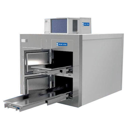 	2 BODYDIEMENSIONS	WIDTH(mm)	1058DEPTH(mm)	2404HEIGHT(mm)	1785SHEET METAL SKIN	INTERIOR FINISH	PRE-PAINTED GI SHEET /SS304EXTERIOR FINISH	PRE-PAINTED GI SHEET /SS304FRONT FINISH	STAINLESS STEEL IN NO2 FINISH SS304DOOR&DOOR FRAME	STAINLESS STEEL ,PLASTIC GROOVED EXTRUSION WITH REPLACEMENT OF GASKET PROVISIONFOAMED PANELS	INSULATION THICKNESS(mm)	80INSULATION MATERIAL	RIGID POLYURETHANE FOAM(CFC  FREE),DENSITY 40 Kg/m 3 AS PER TOL STANDARDLOCKING MECHANISM	CAM-LOCKS EMBEDDED IN FOAMSTANDARD ACCESSORIES	LAMP	BULK HEAD LUMINARY,CFL-W.230WTEMPERATURE INDICATOR-CUM--CONTROLLER	ELECTRONIC WITH DIGITAL DISPLAYCARRIAGE ASSEMBLY	THREE PIECE,TELESCOPIC ACTION,GI POWDER COATEDMORTUARY TRAY	ONE PIECE STAINLESS STEEL TRAY WITH TUBULAR EDGE AND HANDLESREFRIGERATING SYSTEM(ROOF TOP MOUNTING UNITARY)	CAPACITY(BTU/H)	6000POWER SUPPLY	230V/1HP/50HzCOMPRESSOR POWER(KW)	1.25 FOR R22, 0.91 OR R404aTOTAL UNIT POWER CONSUPTIONS(KW)	1.75 FOR R22, 1.4 FOR 404aOPERATING CONDITION(PRESET BY FACTORY)	4  ̊ C  ROOM TEPMPERATURE AT 35  ̊ C   AMBIENTOVERALL DIEMENSIONS(mm) OF REF UNIT	1140(L)X900(W)X600(H)REFRIGERANT(kg)	1.25 FOR R22 , 1.2 FOR R404a