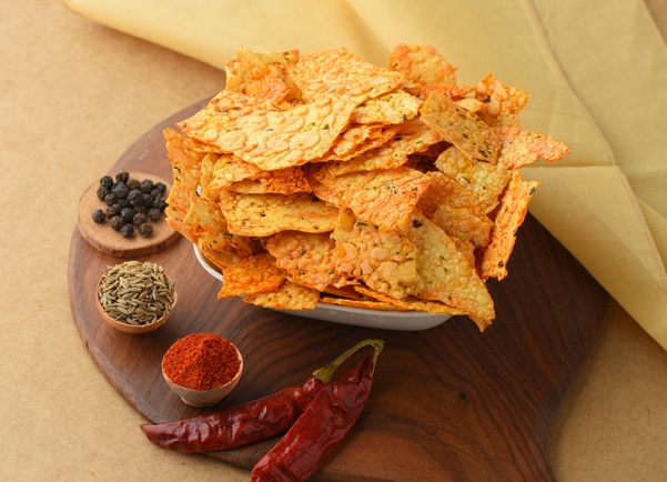 Papad Churi is a traditional rajasthani style dish that can be served even with meals. It is basically a mixture of crushed papads. There can be many different versions of having this snack like some people prefer to add tomatoes, onions or bhujia sev. All of the combinations tastes really good.