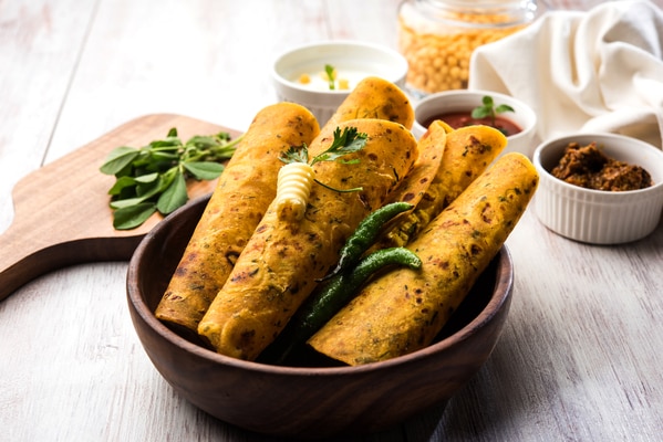 Vaccum Thepla are a traditional delightful snack of Gujarati Cuisine. They are basically non stuffed fenugreek rotis which are shallow fried in oil. They can be rolled with cheese, dipped in curd or can be taken with pickle any time of the day to make a complete meal. They have a long shelf life so they serve as a great accompaniment while traveling.