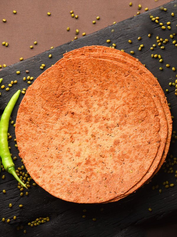 Green Moong Khakhra is a delicious and crispy snack from Rajasthani Cuisine. It is prepared with crushed moong dal along with whole wheat flour and very few spices. It is a power house of proteins and ideal for those who wish to shed extra kilos. You must try this salty and crunchy low calorie khakhra.