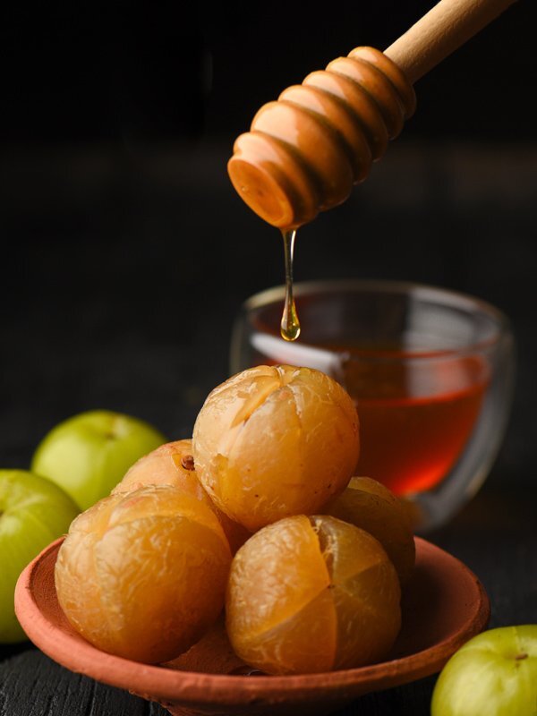 Honey amla is a deliciously sweet and sour treat. Honey and amla both are known to reap many health benefits. Amla is highly useful in treating skin diseases and has an extremely high vitamin C content. It also helps in giving clear skin and enriching hair growth. Honey on the other hand helps in healing wounds and infections.