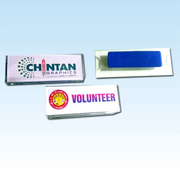 Name badges help you flaunt your association with your company and your position with pride. Conventionally, the name badges have pins or clips that can pierce holes and tear the fabric of your clothes.Magnetic Name Badges are great alternatives to the traditional name badges. Instead of wearing a name card or hanging it around our neck, you can simply use a name badge. Not only does a magnetic name card add a sophisticated look, but it also prevents the damage done to your clothes by pins or clips.The magnetic name badges come with a good-quality magnet that will hold your badge in place without letting it fall or get misplaced. You can easily wear and remove it.These Magnetic Name Badges are durable, convenient to use, and of excellent quality. You can get these name badges customised with your company logo, name, designation, or any other details you want. To generate artworks for multiple people, you can simply upload an excel file with all the names and multiple artworks will be automatically generated. All of this content can be printed in full colour and in any size you want. You just need to pick the size and design, rest will be done for you. Once you place the order, it will be delivered to your doorstep.Sizes Available:7001 Golden : 75mm (w) x 32mm (h)7001 Silver : 75mm (w) x 32mm (h)7011 Golden : 65mm (w) x 20mm (h)7013 Golden : 70mm (w) x 30mm (h)7021 Clear : 75mm (w) x 20mm (h)7024 Clear : 70mm (w) x 25mm (h)Printing: Digital Printing