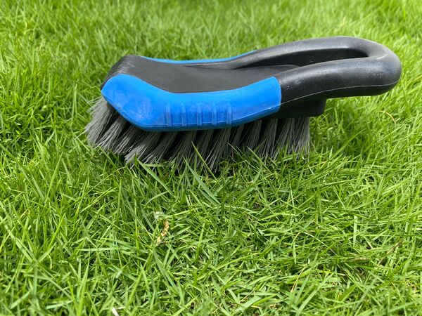 Unlike a broom, which has soft bristles to sweep dirt away, a scrubber has hard bristles for brushing. It may therefore be used wet, with water or cleaning fluids. Around the brush head there may also be a removable floorcloth or mop, either soaked in water for cleaning or dry for wiping dry.