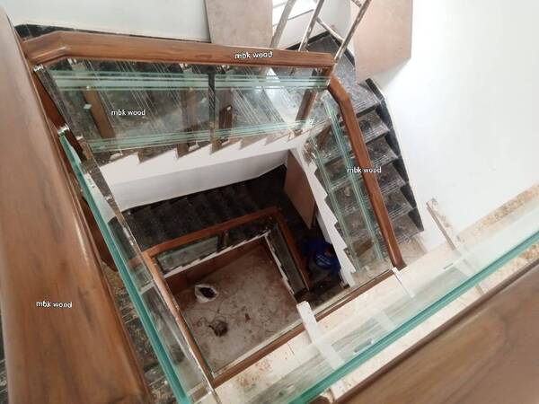 Wooden teakwood home staircase with ss design pillar size 60mm by 60mmHandle size 75mm x 48mmWith finishing polish natural colors best designe mbk wooden carving works price per square feet 2450 complete