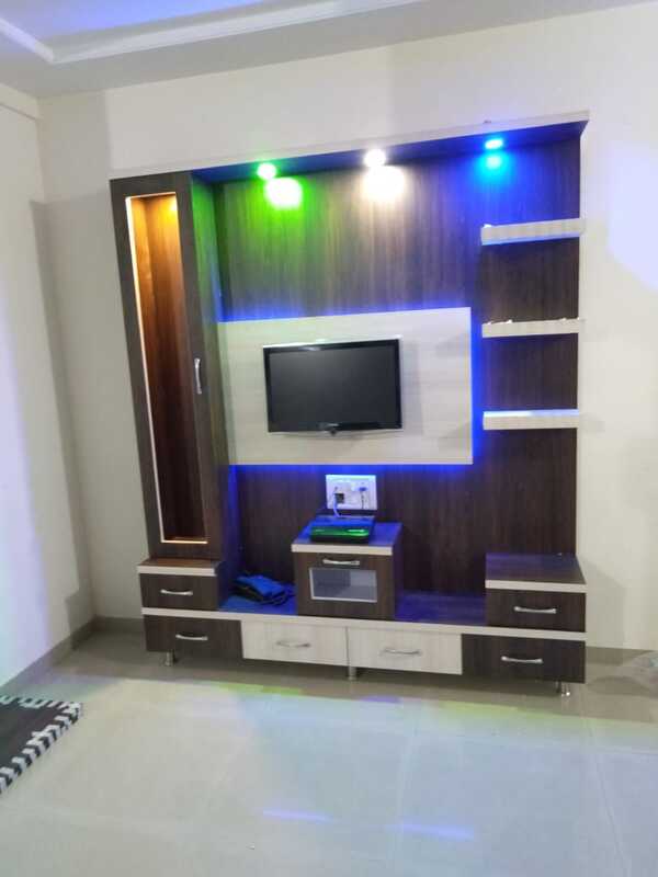 TV units today have become versatile both with purpose and functionality. No longer do TV sets hold viewers hostage to a cricket match or the latest blockbuster movie. In lounge rooms and bars TV is a point of convergence – the axis of social interactions and banter. At homes, urban dwellers have dedicated spaces for TV units, home theatre systems and other recreational gadgets. And for others, binge watching in the bedroom after a long day of work continues to be household tradition. TV units therefore have become an integral part of home interior design with millenials. It’s an indispensable piece of style. It can even upgrade the appearance of your room several notches. In any case, you’ll have to ensure that the structure of your TV unit matches the dimensions of your living your room. And so we bring you  TV unit designs ideal for your living room – those that are adaptable to varied room sizes and gorgeous to look at as well!