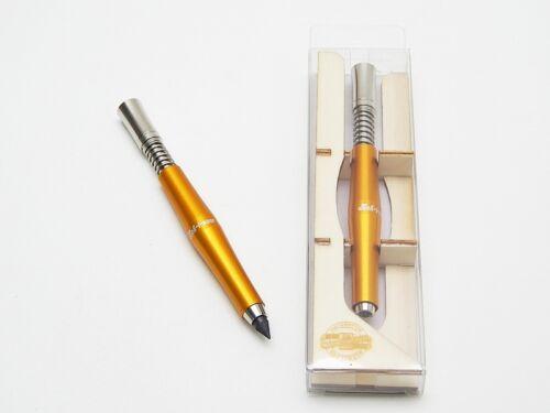 KOH-I-NOOR Mechanical propelling pencil 5330 is made from metal. The metal body is an aluminium alloy and has a round shape. The stylish Gold colour is achieved through anodic oxidation. Anodic oxidation increases corrosion resistance and wear resistance. It is used for writing, drawing & sketching. It is the perfect tool for Designers & Architects. This lead holder holds leads of 5.6 mm diameter.There is a sharpener connector between the sharpener and the body, where the spring is inserted. The lead is moved by pressing the sharpener knob in a leaned pencil position. Upon pressing the knob, the clamp opens and the lead slides out. The lead can be sharpened using the sharpener which is in the knob that has to be screwed out. The graphite lead can be replaced by pastel leads.The mechanical pencil is stored in a wooden stand. The KOH-I-NOOR logo is laser engraved on the cylinder part of the body and on the upper part of the stand.