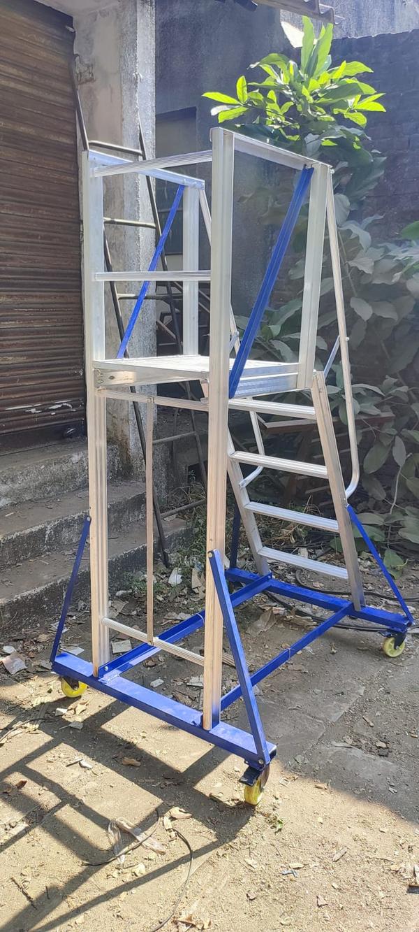 Aluminium Trolley Step LadderAn aluminium trolley step ladder is a type of ladder that is made of lightweight and durable aluminium material and has a trolley base for easy movement. It is designed with steps and a platform at the top for standing, making it suitable for reaching high places such as shelves, ceilings, and roofs.The trolley base of the ladder is equipped with wheels and handles for easy transportation from one location to another. This feature makes it ideal for use in industries, warehouses, and construction sites where the ladder needs to be moved frequently.The steps of the ladder are usually wide and non-slip, providing stability and safety to the user. Some models may also have handrails for extra support.Overall, an aluminium trolley step ladder is a versatile and practical tool for various applications that require safe and easy access to elevated areas.Material-AluminiumLadder Type- Self Supported LadderUsage/Application-IndustrialDesign Type-Movable LadderLoad Capacity-150 KgSurface Finishing-PolishedSteps-18