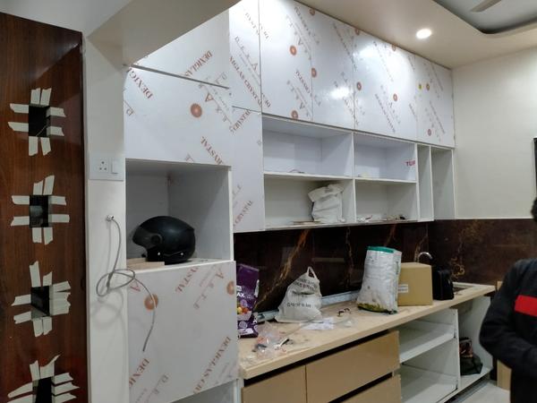 A modular kitchen normally consists of wooden cabinets, countertops, internal accessories including built-in covered baskets, and household and kitchen appliances such as a washbasin, dishwasher, chimney, cooking range/stove, and microwave oven.