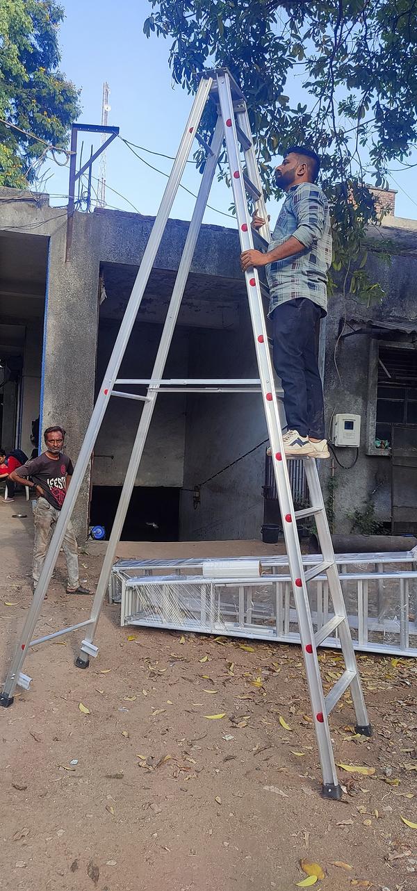 An aluminum folding ladder is a type of ladder made from aluminum that is designed to be easily foldable and portable. It is a versatile tool that can be used for various purposes, both indoors and outdoors. Aluminum is a popular material for folding ladders due to its lightweight nature, durability, and resistance to rust and corrosion.Aluminum folding ladders typically feature hinged joints that allow them to fold compactly for easy storage and transportation. They often have multiple sections or rungs that can be extended or retracted, allowing the ladder to reach different heights based on the user's needs. Some models may also have locking mechanisms or stabilizers to enhance safety and stability during use.These ladders are commonly used for tasks such as painting, cleaning, reaching high shelves, or performing maintenance work. They are favored by homeowners, contractors, and professionals who require a portable and convenient ladder solution. Country of Origin-Made in IndiaIs It Foldable-FoldableIs It Anodised-AnodisedHeight-6 Feet,8 feet,10 Feet,12 Feet.14 Feet,16 Feet,20 FeetMaterial-AluminiumColor-SilverChannel Section-66*31 mmStep Width-2.5 inchMaterial Thickness-2mm,2.5mm,3mmLadder Type-A TypeLoad Capacity-150 KgUsage/Application-Industrial,Construction,Home Use