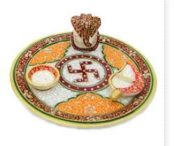Enhance your devotion with this gorgeous multicolored marble Ganesha puja thali with conch.Bring home this gorgeous marble diwali Ganesh pooja thali and take devotion to a new level. It will also enhance your home temple. It has Ganesha, a small bowl & a conch with beautifully crafted & painted swastik in the center of thali (with meenakari & stone). Best wedding gifts under 1000 rs or diwali gifts online.