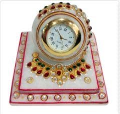 This richly decorated marble paperweight style clock with beautiful meenakari work is perfect to decorate your home with utility item.Home decor can be enhanced with useful items like this richly decorated clock. This diwali bring home this exquisite marble paperweight style clock with beautiful meenakari work. It can be useful as well as a handmade decorative item for your drawing room. Gift this exclusive item to people you care about and get appreciated for your choice. Best as diwali gifts for employees under 500 or return gifts for wedding or retirement return gifts!