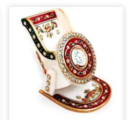 Entice buyers to keep their precious smartphones in this classy Meenakari Marble Mobile Stand with Clock.The meenakari marble mobile stand with clock features the fine tradition of meenakari work throughout its pristine white marble body, which makes it a mesmerizing piece of handicraft item. The lively combination of the red and green shades brings forth the inherent beauty of the meenakari work. Finally, the presence of a handy clock in the middle of this piece seals the deal in its favor makes it most suitable corporate gift item.