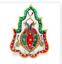 Place your keys in this beautifully designed key holder and enhance the decor of your wall of home or office.This is a richly decorated key holder for wall carved out of marble. It will enhance the look of the key and ideal as handmade wall decor. This can be a perfect piece of small gift to your near and dear ones on the festive occasion of diwali. This will serve as a memento of your love and care. You should also get one for your use. Best as housewarming return gifts or diwali gifts for employees under 500!