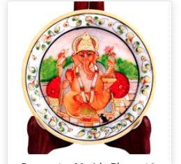 This decorative marble plate with Ganesh figure is sure to add effortlessly to the piousness of any household it adorns.The decorative marble plate with Ganesh figure is sure to make for a mesmerizing addition to any wall decor with the exquisite painting of Lord Ganesh at its center. This alone makes it highly desirable among the ardent devotees of Lord Ganesh for driving away evil and ushering peace and prosperity into the household. Moreover, the presence of the intricate floral design all along the border region of this marble plate adds to its visual appeal and makes it aesthetically suitable to add to the visual splendor of wall decor of any house it adorns. It can also be gifted as a wedding favor.