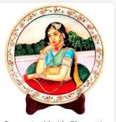 This decorative marble plate with Rajasthani Bani Thani figure is sure to make the wall decor of any household it adorns resplendent.The decorative marble plate with Rajasthani Bani Thani figure can be the perfect choice for the lovers of Indian traditional artwork, with the delightful Rajasthani Bani Thani figure at the center making the cynosure of all eyes. The lush colors used for the painting provides stark contrast to the pristine backdrop of the marble body. Moreover, the intricate design works present in the form of the floral patterns along the border region makes this decorative marble plate a piece to behold and appreciate.