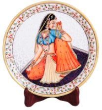 This decorative marble plate with Rajasthani Ragini figure is sure to add traditional sensibility to even the most contemporary of wall decor.The decorative marble plate with Rajasthani Ragini figure features a mesmerizing display of Indian ethnic artwork in the form of the beautiful painting of Rajasthani damsel at its center. The traditional artwork brings to life the subtle feminine grace of the figure, while the pristine marble body of the plate serves as the perfect backdrop. Moreover, the delicate design work present along the border portion of the marble plate adds to its attractiveness and makes it suitable for even the most lavish of wall decors and a presentable Indian ethnic gift.