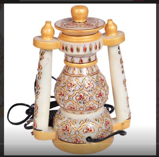 his decorative marble lantern with floral design work is ideal for lighting up any household in an aesthetic avatar.The decorative marble lantern with floral design work features intricate design work in the form of delicate floral patterns on the pristine marble body to make it a sight to behold. This decorative lantern works on electricity and is capable of providing light to any household during periods of an emergency such as power outages. Therefore, this item brings to the table the winning combination of aesthetically pleasing design along with great practical application to make it suitable for the households or a worthy wedding return gift option.