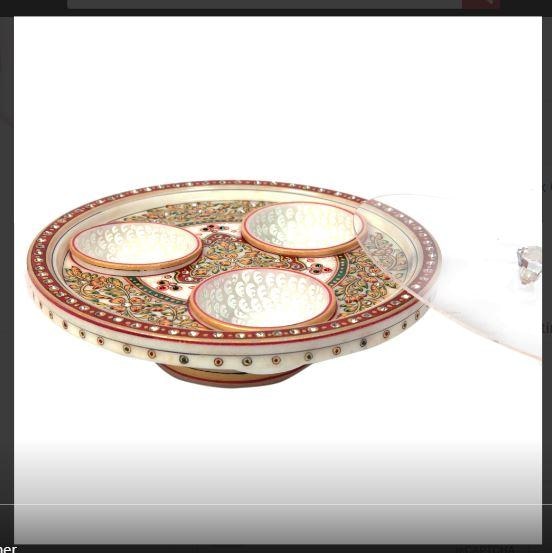 The decorative marble mouth freshener & dry fruit container contains three separate bowl-shaped partitions to keeping multiple numbers of mouth fresheners, as well as, dry fruits in the most aesthetic of settings. This marble container features exquisite traditional design work to make it suitable for the most lavish of dinner tables, and other surroundings. Moreover, the quality of the design work present on its body complements the finest grade marble used in its construction to make it suitable for even the most regal of households. This marble dry fruit container is among the most lavish wedding return gift.