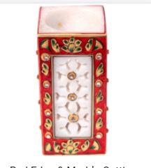 The use of beads further enhances the beauty of this magnificent marble meenakari piece of artwork that is a perfect example of great traditional arts and crafts of India and the delicate skill of marble cutting.What makes this rectangular marble carved pen stand truly stand out is its magnificent marble cutting work bordered by red and gold minakari work. The use of beads further enhances the beauty of this magnificent piece of Indian crafts that is a perfect example of traditional Indian gifts.