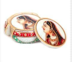 The marble crafted tea coaster holder itself is a mesmerizing piece of traditional Indian artwork with beads and meenakari work in red, green and golden hues on a marble base.This 6 piece marble meenakari tea coaster is adorned by the hand-painted image of a gorgeous lady that immediately catches the eye of the beholder. The holder itself is a mesmerizing piece of artwork with beads and minakari work in red, green and golden hues on a white background. Best return gifts!