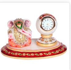 Both the marble handicraft Ganesh idol and the table watch are decorated colorfully and adorned with beads to enhance their elegant look and depicts traditional arts and crafts of India further.A perfect return gifts for any occasion, this handmade decorative item consists of a small marble idol of Lord Ganesh and a pillar clock with well-proportioned dimensions. Both the Ganesh idol and the pillar watch are handcrafted colorfully and adorned with beads to enhance their elegant look and exclusive artwork further.