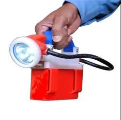 The lamp consists of a maintenance-free housed in to a battery container having moulded in belt-loops & air tight Lid marked with positive (+) & negative (-) output terminals. The main terminals are suitably protected by a moulded Top-cover with special locking arrangements. The Top-cover is assembled with a flexible Cable at one end and the other end of the cable is housed into a compact Head-piece unit provided with a Cap hook, a Rotary switch, a highly polished deep parabolic metal Reflector fitted with power, 110 lumens of which the basic life is 50,000 hours which is finally protected with a glass-disc sealed by a suitable Lese-ring & locked with a special pin to avoid unauthorized tampering. The hand cap light unit is re-chargeable from any conventional type of charging-racks or by single point charger unit also through its head-piece unit by conventional system. The rated voltage of the charger to be maintained within 4 volts preferably. Finally the Cap Light is designed to meet all the required facilities for self-service operation. Weight: 750 gBody Material: ABSIP Rating: IP55Lighting Type: LEDUsage/Application: Hand Held Search LightVoltage: 3.6 V