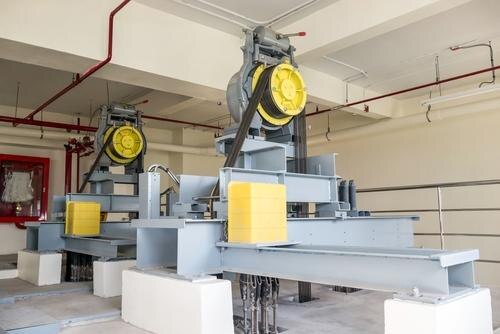 In commercial applications, the use of higher voltage and required dedicated machine room leaves the fact that at least 25 sq. ft. valuable space is needed for the elevator equipment. With overhead machinery and traction elevators (and in some cases even hydraulic) the machine room can simply be located above the elevator hoistway as long as there is proper access to it and enough room for it.