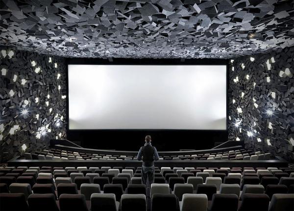 The concept of a luxury cinema integrates two distinct notions: luxury and the cinematic experience.

Seating Concepts offers a diverse range of luxury and VIP options to cater to the diverse spectrum of premium theater themes and designs.
At the core of the luxury theater concept are numerous waiting areas meticulously designed for utmost comfort and relaxation. These areas encompass outdoor spaces equipped with patio heat lamps, a lobby featuring a bar and exuding a tranquil ambiance with reduced foot traffic, a lounge area furnished with a large-screen TV, a cafe, a restaurant, a patisserie, and a movie-centric bookshop.

The flooring is elegantly carpeted, and there exists an approximate five-foot gap between each seat and the one in front. The cushioned seats are equipped with an attached swivel tray, customized swivel dining tables, a conveniently placed cup holder within the armrest, and a recline button that also elevates the footrest. Additionally, a service call button is provided, enabling patrons to have food or beverages, including both alcoholic and non-alcoholic options, brought directly to their seats.

Customers are treated to an unparalleled VIP cinematic experience akin to the most sophisticated in-home movie theaters and lounges. The settings offer a variety of features, ranging from fully reclining seating, cutting-edge 2K/4K digital projection, top-tier surround sound, to complete 3D capability.

This fusion of cinema and dining guarantees that the luxury movie theater evolves into a cultural and entertainment landmark, a burgeoning trend particularly in India.

These luxury cinemas boast state-of-the-art kitchen equipment and a comprehensive bar service, further enhancing the overall experience.