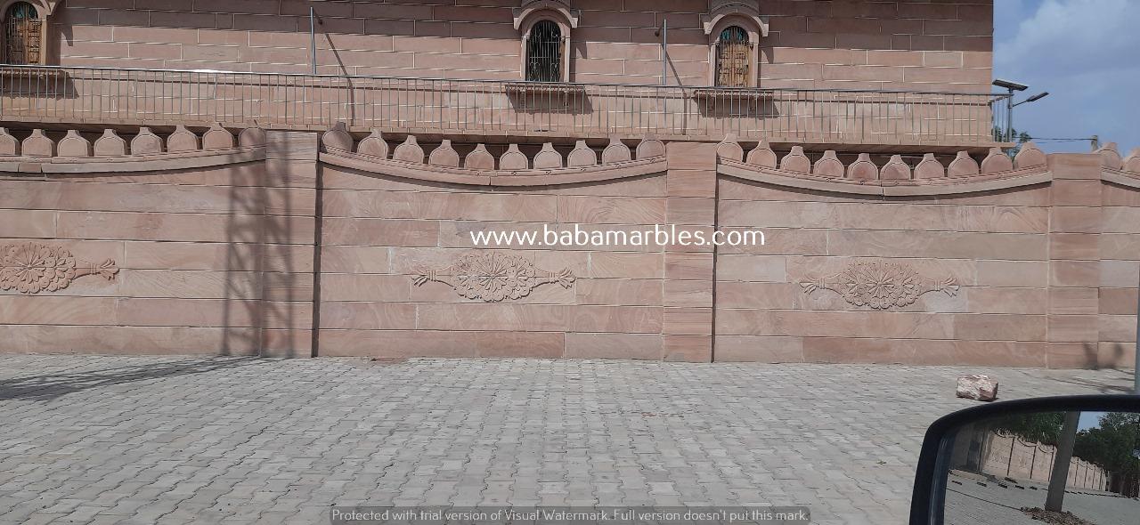 A Jodhpur Sandstone Wall is a captivating testament to the rich architectural heritage of Jodhpur, an iconic city in the state of Rajasthan, India. Crafted from the famed Jodhpur sandstone, these walls are renowned for their warm and earthy hues that create a striking visual impact. What distinguishes these walls is their exquisite carvings, which often feature intricate patterns, floral motifs, and traditional Rajasthani designs. These walls serve both practical and aesthetic purposes, providing sturdy boundaries to structures while adding an air of timeless elegance to the landscape. The use of Jodhpur sandstone in construction is not only a nod to the city's cultural heritage but also a celebration of the enduring craftsmanship and artistic traditions that have shaped the region's architectural identity. These walls stand as a symbol of Jodhpur's history and are a visual delight that resonates with the city's distinctive charm.